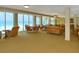 Bright lounge area with ocean view, wicker furniture, and plenty of seating at 2295 Gulf Of Mexico Dr # 64S, Longboat Key, FL 34228