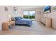 Bright bedroom with sliders to balcony, featuring beach views and simple decor at 2295 Gulf Of Mexico Dr # 64S, Longboat Key, FL 34228