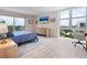 Bright bedroom with sliders to balcony, beach views, and a dedicated workspace at 2295 Gulf Of Mexico Dr # 64S, Longboat Key, FL 34228