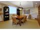 Meeting room featuring a large wooden table and stone wall decor at 2295 Gulf Of Mexico Dr # 64S, Longboat Key, FL 34228