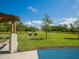 A picturesque park with manicured lawn, picnic shelter, and barbecue grills on a sunny day at 2295 Gulf Of Mexico Dr # 64S, Longboat Key, FL 34228