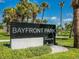 Bayfront Park sign with beautiful landscaping and palm trees indicating a welcoming public space at 2295 Gulf Of Mexico Dr # 64S, Longboat Key, FL 34228