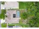 Aerial view of home with pool, solar panels and fenced backyard with mature trees at 2381 Appaloosa Cir, Sarasota, FL 34240