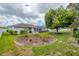 Expansive backyard featuring lush lawn, mature landscaping, and a screened-in lanai, perfect for outdoor living at 2381 Appaloosa Cir, Sarasota, FL 34240