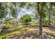 Lush backyard with mature trees offering shade and privacy, along with a secure fence at 2381 Appaloosa Cir, Sarasota, FL 34240
