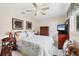 Cozy bedroom with neutral walls, ceiling fan, and comfortable furnishings at 2381 Appaloosa Cir, Sarasota, FL 34240