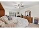 Spacious bedroom with ample natural light, ceiling fan, and wooden dresser at 2381 Appaloosa Cir, Sarasota, FL 34240