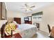 Bedroom featuring a ceiling fan, carpet floor, window and nice lamp at 2381 Appaloosa Cir, Sarasota, FL 34240