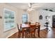 Dining area with wood floors, pool views, and ceiling fan at 2381 Appaloosa Cir, Sarasota, FL 34240