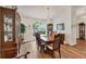 Charming dining area with hardwood floors, chandelier, and a bright window view at 2381 Appaloosa Cir, Sarasota, FL 34240