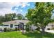 Inviting single-story home boasts mature trees, manicured lawn, and white picket fence at 2381 Appaloosa Cir, Sarasota, FL 34240