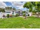 Inviting home with a lush front yard featuring mature trees, well-maintained landscaping, and a welcoming entrance at 2381 Appaloosa Cir, Sarasota, FL 34240