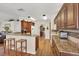 Bright kitchen features wood floors, breakfast bar, wood cabinetry, and granite countertops at 2381 Appaloosa Cir, Sarasota, FL 34240