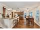 Bright kitchen features wood floors, breakfast bar, wood cabinetry, and stainless appliances at 2381 Appaloosa Cir, Sarasota, FL 34240