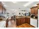 Open kitchen and dining area features granite countertops, wood floors, and recessed lighting at 2381 Appaloosa Cir, Sarasota, FL 34240