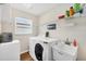 Efficient laundry room with modern washer, dryer, and utility sink at 2381 Appaloosa Cir, Sarasota, FL 34240