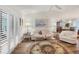 Open living room with hardwood floors, plantation shutters, and tasteful decor at 2381 Appaloosa Cir, Sarasota, FL 34240