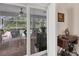 Screened patio with brick floor, view of the backyard pool, and stylish outdoor furniture at 2381 Appaloosa Cir, Sarasota, FL 34240