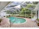 Sparkling pool surrounded by brick pavers and a screened enclosure at 2381 Appaloosa Cir, Sarasota, FL 34240