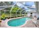 Relaxing pool with screened enclosure and well-maintained landscaping at 2381 Appaloosa Cir, Sarasota, FL 34240