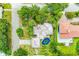 Aerial view showing a quaint home with a pool and lanai surrounded by lush, mature landscaping at 2504 Mulberry Ter, Sarasota, FL 34239
