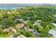 Beautiful aerial view of neighborhood homes surrounded by water and lush trees under a clear sky at 2504 Mulberry Ter, Sarasota, FL 34239