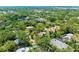 A lovely home is nestled amongst trees and other houses within a quiet neighborhood, with mature landscaping all around at 2504 Mulberry Ter, Sarasota, FL 34239