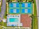 Aerial view of the community pool, clubhouse, and tennis and pickleball courts at 25100 Sandhill Blvd # 104 G, Punta Gorda, FL 33983