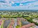 An aerial view of the community featuring condos surrounding a pond at 25100 Sandhill Blvd # 104 G, Punta Gorda, FL 33983