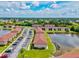 An aerial view displays the community condos, a serene pond, and convenient parking spaces at 25100 Sandhill Blvd # 104 G, Punta Gorda, FL 33983