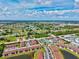 Aerial view of a community featuring multiple condo buildings, landscaping, and community areas at 25100 Sandhill Blvd # 104 G, Punta Gorda, FL 33983