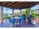 Covered outdoor dining and BBQ area with table, chairs, and grills at 25100 Sandhill Blvd # 104 G, Punta Gorda, FL 33983