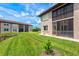 Exterior of condo featuring a well-manicured lawn, adjacent waterway, and comfortable screened in lanai at 25100 Sandhill Blvd # 104 G, Punta Gorda, FL 33983