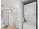 Bathroom featuring a shower, a vanity, and a stacked washer-dryer unit at 25100 Sandhill Blvd # 104 G, Punta Gorda, FL 33983