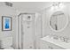 Bathroom with a glass enclosed shower, white vanity, and tile accents at 25100 Sandhill Blvd # 104 G, Punta Gorda, FL 33983