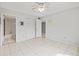 Bedroom featuring tile floors, ceiling fan, closet space, and ensuite bathroom access at 25100 Sandhill Blvd # 104 G, Punta Gorda, FL 33983