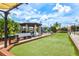 Outdoor bocce ball court with shaded pergola, BBQ, and seating area at 25100 Sandhill Blvd # 104 G, Punta Gorda, FL 33983