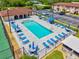 Aerial view of the community pool, lounge chairs, tables, and pool house at 25100 Sandhill Blvd # 104 G, Punta Gorda, FL 33983