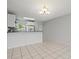 Open concept dining area with tile floors and modern lighting fixtures at 25100 Sandhill Blvd # 104 G, Punta Gorda, FL 33983