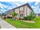 Exterior view of a two-story condo building with lush green lawn at 25100 Sandhill Blvd # 104 G, Punta Gorda, FL 33983