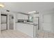 Bright kitchen featuring white cabinets, modern appliances, and a tile backsplash at 25100 Sandhill Blvd # 104 G, Punta Gorda, FL 33983