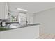 Well-lit kitchen with white appliances and tile flooring, perfect for cooking at 25100 Sandhill Blvd # 104 G, Punta Gorda, FL 33983