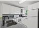 Bright and clean kitchen with white cabinets and modern fixtures at 25100 Sandhill Blvd # 104 G, Punta Gorda, FL 33983