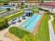 Overhead image of shuffleboard courts with seating and covered gazebo near condo community at 25100 Sandhill Blvd # 104 G, Punta Gorda, FL 33983