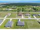 Aerial view of a single-Gathering home with a red roof and green lawn in a suburban neighborhood at 25324 Alicante Dr, Punta Gorda, FL 33955