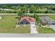 Featuring a charming single-story home with a spacious lawn and lush trees at 25324 Alicante Dr, Punta Gorda, FL 33955