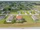 Wide aerial view of a residential community with many single Gathering homes surrounded by green lawns and trees at 25324 Alicante Dr, Punta Gorda, FL 33955
