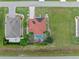 Aerial view of a single-Gathering home featuring a screened-in pool, surrounded by palm trees and lush landscaping at 25324 Alicante Dr, Punta Gorda, FL 33955