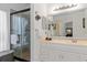 The bathroom features a glass shower and white cabinets at 25324 Alicante Dr, Punta Gorda, FL 33955