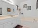 A bright bathroom is equipped with a soaking tub and a vanity sink at 25324 Alicante Dr, Punta Gorda, FL 33955